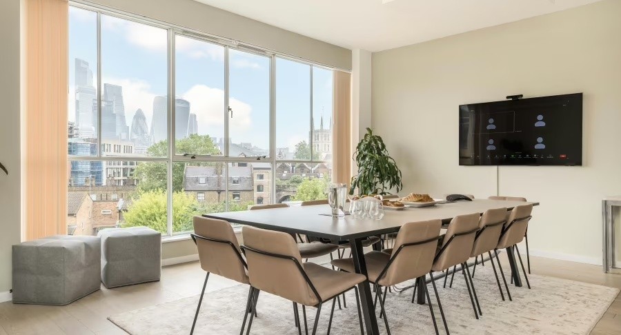 The Menier Meeting Room: a bright boardroom with a long table, wall screen and views over London